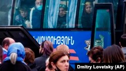 ARMENIA -- Ethnic Armenians look out from a bus window as they return to Stepanakert from Yerevan, Novemebr 16, 2020