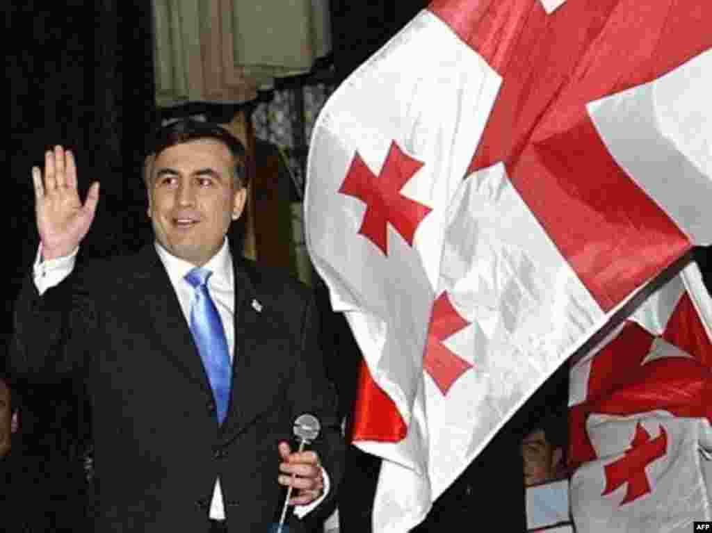 Mikheil Saakashvili waves to supporters in Tbilisi early on election day.