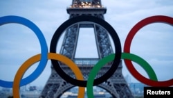 FILE PHOTO: Olympic rings to celebrate the IOC official announcement that Paris won the 2024 Olympic bid are seen in front of the Eiffel Tower at the Trocadero square in Paris