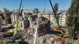 This handout photograph taken and released by the State Emergency Service of Ukraine on August 28, 2025, shows rescuers conducting a search and rescue operation in and around a residential building heavily damaged during a large-scale Russian drone and mi