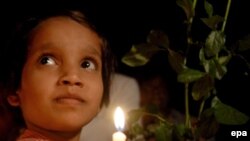 Indian schoolchildren participate in a candlelight vigil outside the Taj Mahal Hotel in memory of those killed in Mumbai.