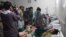Passengers who were injured in the April 23 collision receive treatment at a hospital in Zabul Province.
