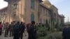 Police and rescue workers stand outside the Directorate of Agriculture Institute in Peshawar on December 1.