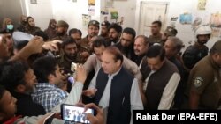 Nawaz Sharif (C), former Prime Minister and leader of opposition party Pakistan Muslim League Nawaz (PML-N), leaves an accountability court after a hearing on money laundry case, in Lahore on October 11.