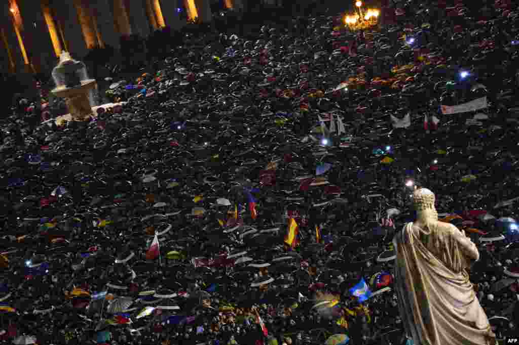 The crowd reacts in St Peter&#39;s Square after white smoke billowed from the chimney of the Sistine Chapel announcing that Catholic Church cardinals had elected a new pope.