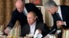 Yevgeny Prigozhin (left), once known as "Putin's chef," serves Russian Prime Minister Vladimir Putin during a dinner outside Moscow in 2011.