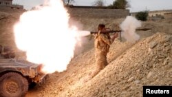 An Iraqi soldier fires a rocket-propelled grenade south of Mosul on November 10.