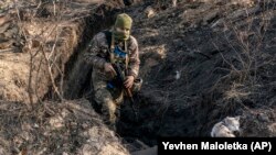 A Ukrainian serviceman in a trench in Zolote in the Luhansk region in November