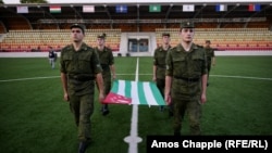 Abkhaz soldiers practicing flag-raising as part of preparations for the Conifa soccer tournament, which kicks off in the Georgian breakaway region on May 28.