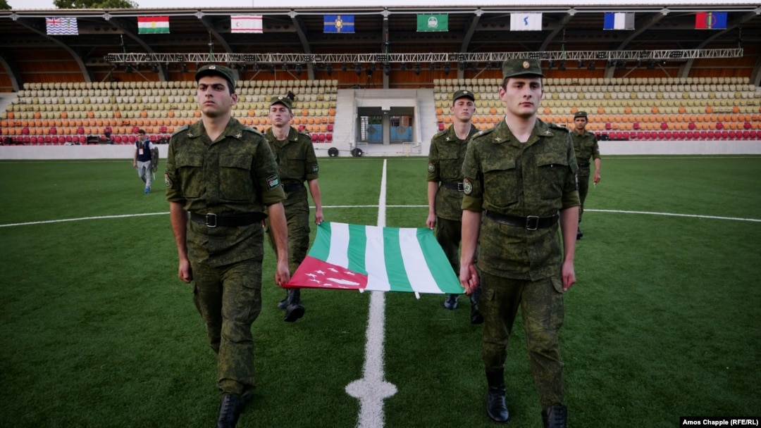Abkhaz soldiers practicing flag-raising as part of preparations for the Conifa soccer tournament, which kicks off in the Georgian breakaway region on May 28.
