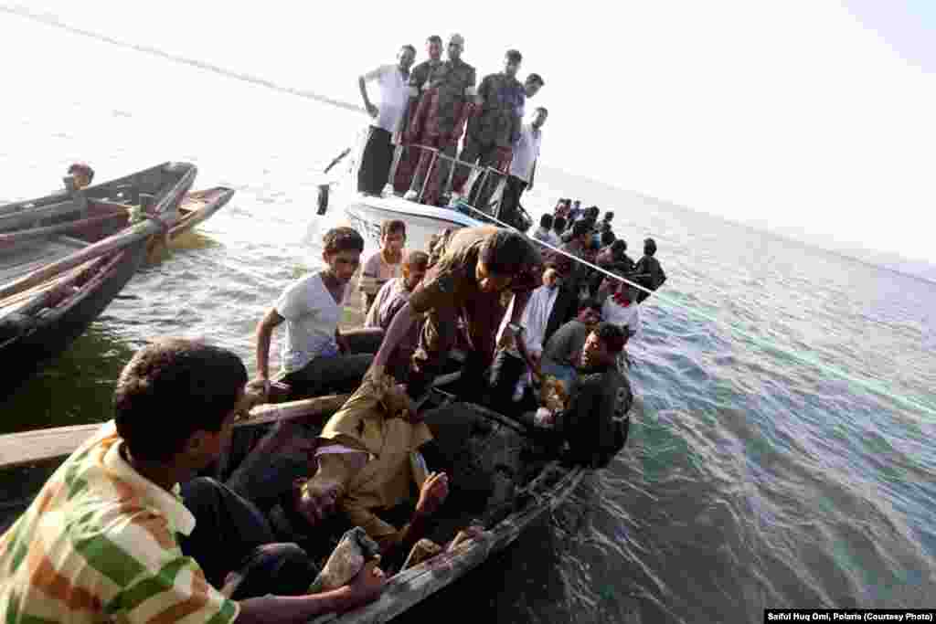 A group of 128 Rohingya people, mostly young men, on nine small boats are intercepted by Bangladeshi border guards. 