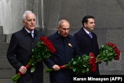 Armenian Prime Minister Nikol Pashinian (center) lays flowers at the Armenian Genocide Memorial in Yerevan on April 24.