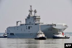 The Sevastopol Mistral warship on its way for its first sea trials off the western port of Saint-Nazaire, France, on March 16.