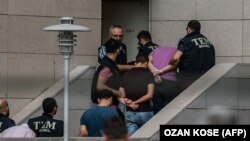 Detained Turkish soldiers who allegedly took part in a military coup arrive with their hands bound behind their backs at the Istanbul Justice Palace (Adalet Sarayi) on July 20.