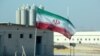 An Iranian flag flies at the Bushehr nuclear power plant, its first, during an official ceremony to kick-start work on a second reactor at the facility in 2019.