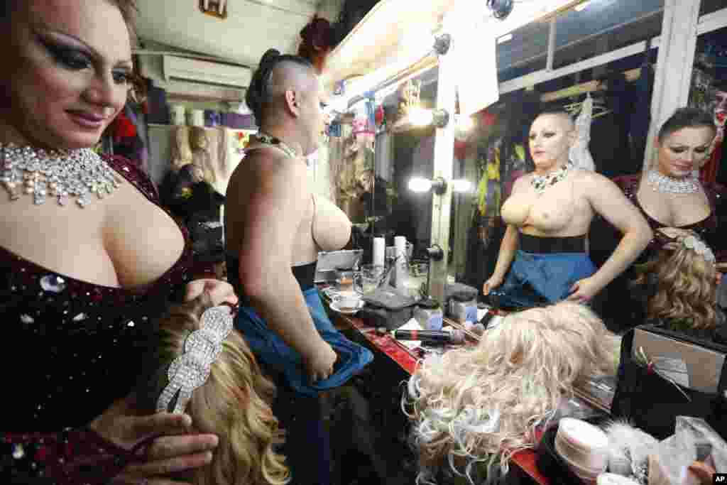 Dancers change costumes during a break in their show at the gay nightclub "Mayak" on September 23.