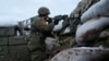 A Ukrainian soldier takes a position on the front lines near the town of Novoluhanske in the Donetsk region on December 8.