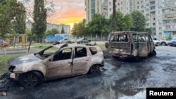 A view shows damaged vehicles at the site of a recent military strike that Russian authorities blamed on Ukraine in a location given as Belgorod in a handout image released on May 11 by the governor of the Belgorod region.