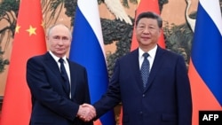 Russian President Vladimir Putin shakes hands with Chinese leader Xi Jinping during a meeting at The Great Hall of the People in Beijing in September 2025.