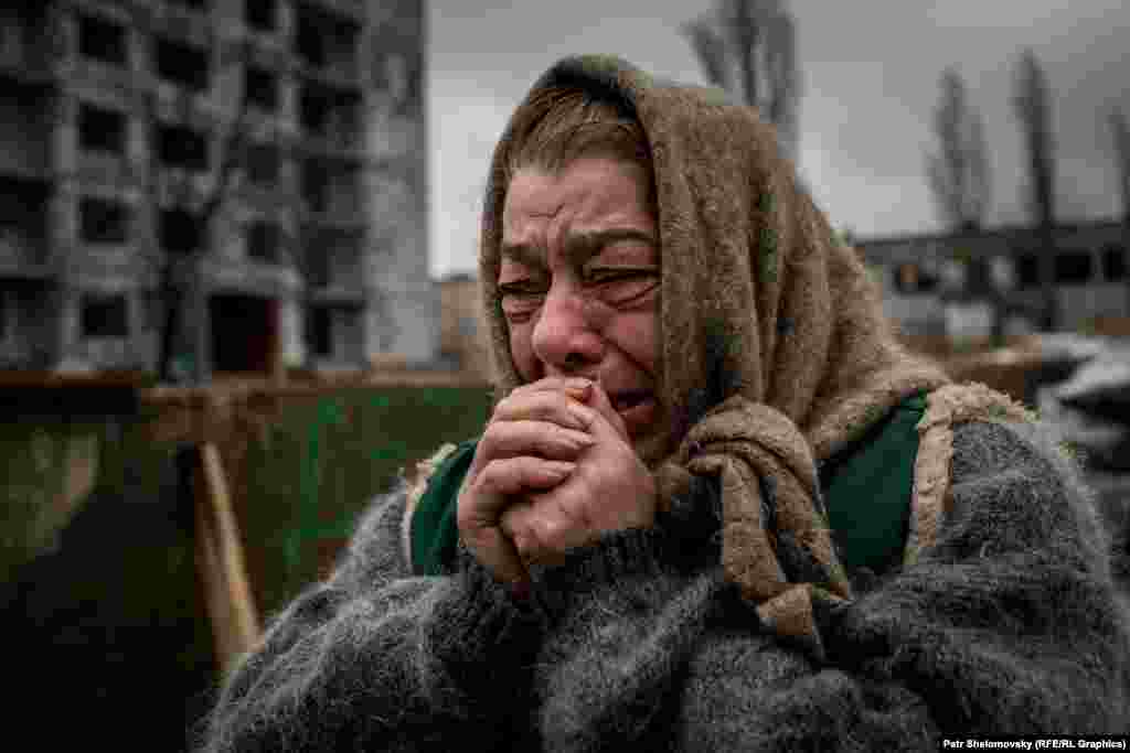 A woman cries as she watches relatives prepare to leave.