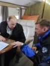 Ukraine -- Russian President Vladimir Putin (C) talks to Deputy Prime Minister Dmitry Kozak (L) and head of the Federal Road Agency (Rosavtodor) Roman Starovoit as they inspect a transport passage across the Kerch Strait, Crimea, March 18, 2016