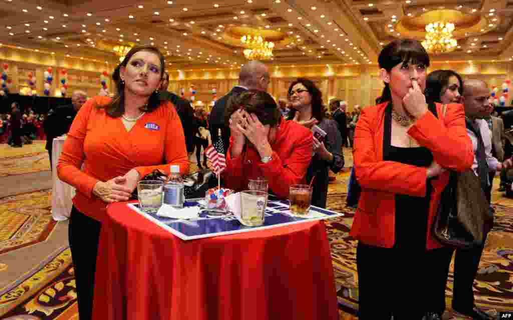 Romney supporters react to the news of Obama&#39;s victory at an election-night party in Las Vegas, Nevada.