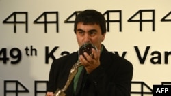 Georgian film director Giorgi Ovashvili poses with the Grand Prix Crystal Globe Award for best film, ''Corn Island,'' during the closing ceremony of the 49th Karlovy Vary International Film Festival (KVIFF) in Karlovy Vary, Czech Republic, on July 12.