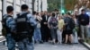 The chairman of Russia's Yabloko political party, Nikolai Rybakov (center), greets supporters after a hearing of the Supreme Court in Moscow on August 10.