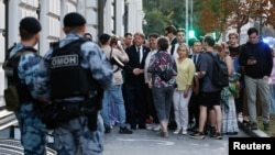 The chairman of Russia's Yabloko political party, Nikolai Rybakov (center), greets supporters after a hearing of the Supreme Court in Moscow on August 10.