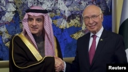 Pakistan's National Security Advisor Sartaj Aziz (R) shakes hands with Saudi Foreign Minister Adel al-Jubeir before their meeting at the Foreign Ministry in Islamabad on January 7.