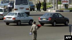 A boy sells flowers in northern Tehran, Iran. File photo