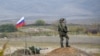 A Russian peacekeeper patrols at the checkpoint outside Askeran.