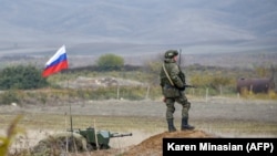 A Russian peacekeeper patrols at the checkpoint outside Askeran.