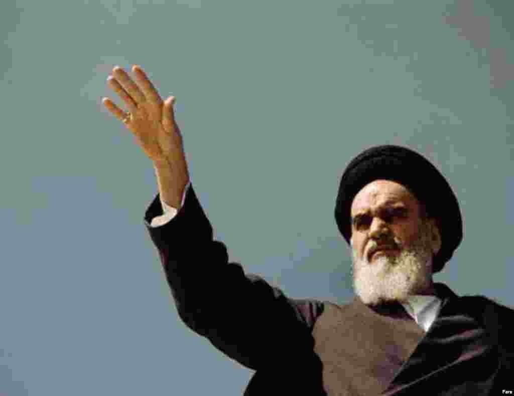 Khomeini greets supporters (Fars) - During his exile, Khomeini developed the theory of Islamic government, one headed by a leading Islamic jurist. He argued for complete adherence to Shari'a, Islamic law.