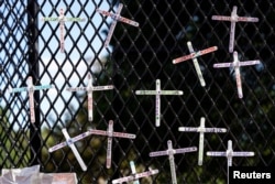 Crosses commemorating African-Americans who have died in police custody, as well as in other violent incidents, are placed on the fence surrounding the White House in Washington, D.C.