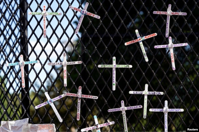 Crosses commemorating African-Americans who have died in police custody, as well as in other violent incidents, are placed on the fence surrounding the White House in Washington, D.C.