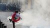 A demonstrator kicks back a tear gas canister during a protest against the government performance and worsening economic conditions, in Beirut, Lebanon June 6, 2020. 