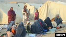 An Afghan family waits for help from the government and aid organizations in Takhar Province on October 11 after fleeing their homes in neighboring Kunduz.
