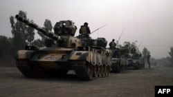Pakistani army tanks form a column during a ground military operation against Taliban militants in the main town of Miranshah in North Waziristan, June 30, 2014.