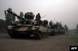 Pakistani army tanks form a column during a ground military operation against Taliban militants in the main town of Miranshah in North Waziristan, June 2014.