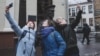 Four actresses from Minsk's Free Theater stage a flash mob near a controversial police statue in the Belarusian capital