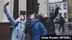 Four actresses from Minsk's Free Theater stage a flash mob near a controversial police statue in the Belarusian capital