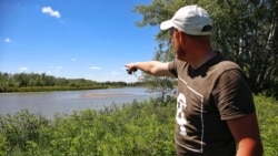 Aleksei, a resident of the village of Bolshoi Chagan, West Kazakhstan region, points out islands in June.