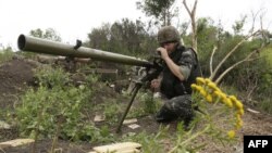 A Ukrainian serviceman prepares his SPG-9 anti-tank grenade launcher near the village of Starognativka, in the Donetsk region. 