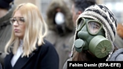 Sarajevo citizens with protective masks protest in front of the government building over dangerous levels of air pollution in Bosnia-Herzegovina on January 20, 2020. 