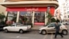 A man walks past the fried chicken shop Halal KFC, which Iranian authorities closed on November 3. 