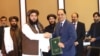 د پاکستان د سوداګرۍ مرستیال وزیر جاوېد پاول (ښي لوري ته) او د طالبانو د صنعت او سوداګرۍ وزارت مرستیال احمد الله زاهد په اسلام اباد کې د هوکړې تر لاسلیک وروسته روغبړ کوي - د جولای ۲۳مې انځور 