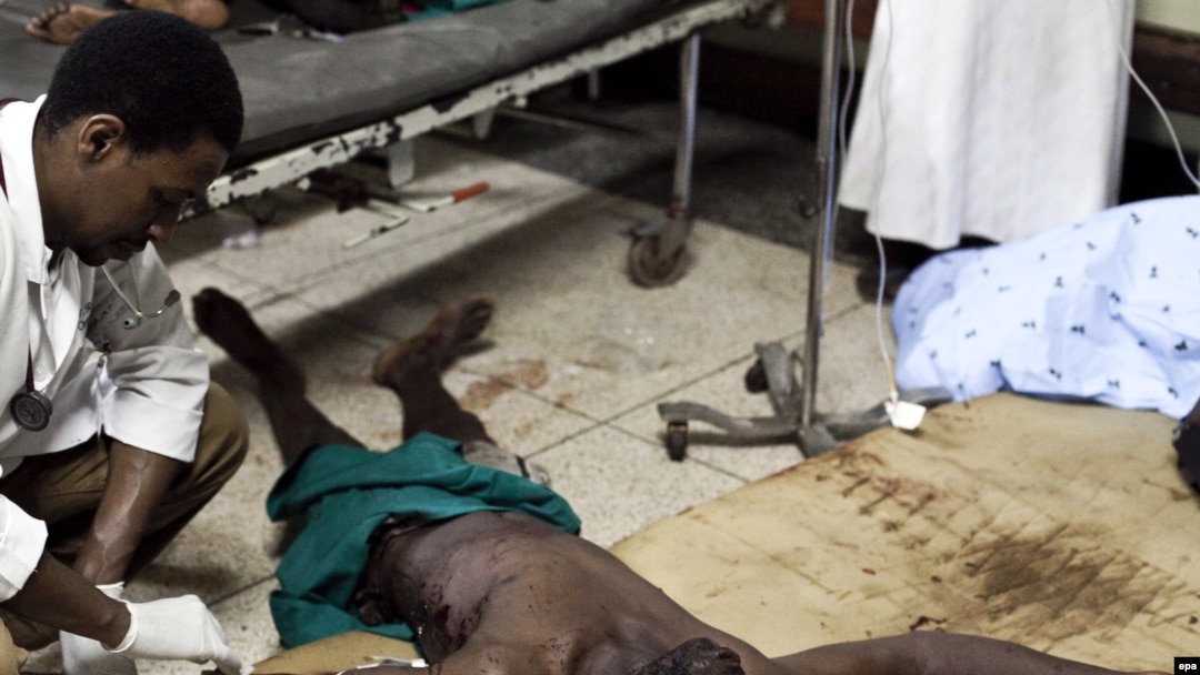 A doctor attends to one of the people injured in one of the Kampala bombings on July 11, when many of the victims were gathered to watch the World Cup final.