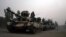 FILE: Pakistani army tanks form a column during a ground military operation in Miran Shah, the main town in North Waziristan.