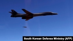 A U.S. Air Force B-1B Lancer drops a bomb at a shooting range in Gangwon Province, east of Seoul, in a drill on August 31, 2017.